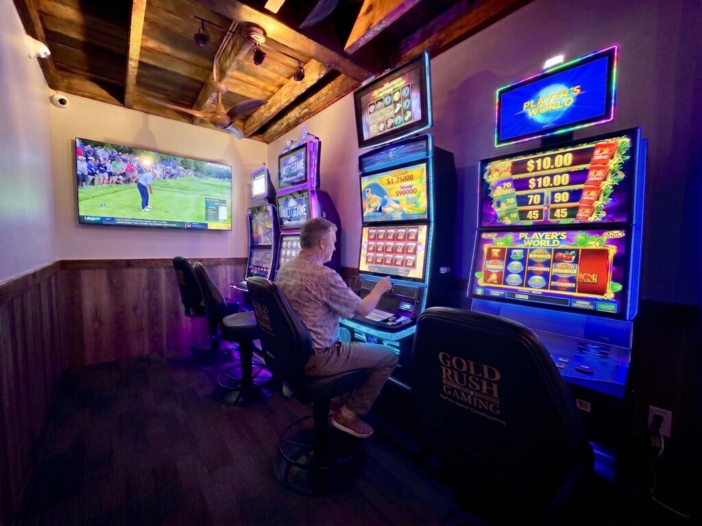 Slots video gaming room with sports on the TV